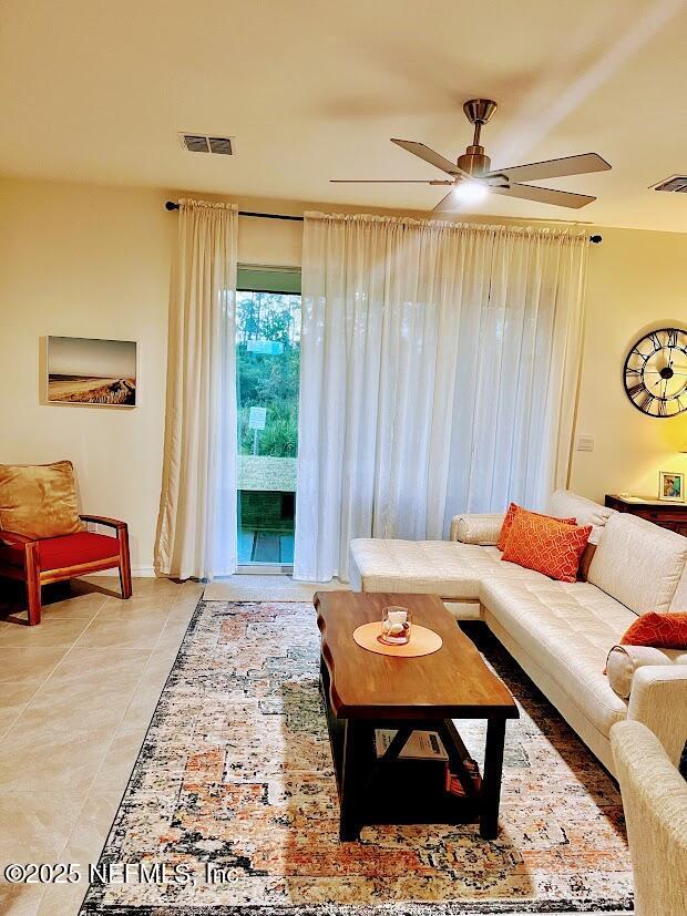 172 Reena Dr, Daytona Beach, FL 32117 - living room with a ceiling fan, light tile patterned floors, and baseboards
