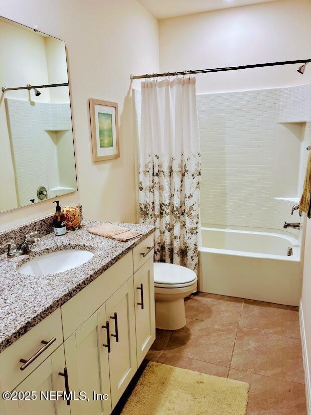 172 Reena Dr, Daytona Beach, FL 32117 - full bath featuring shower / tub combo with curtain, toilet, vanity, and tile patterned flooring