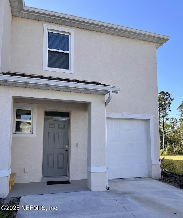 172 Reena Dr, Daytona Beach, FL 32117 - entrance to property with stucco siding, a garage, and concrete driveway