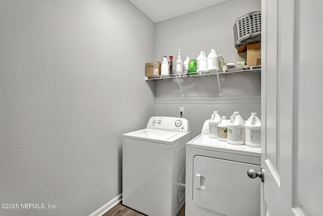 1860 Cogdill, Middleburg, FL 32068 - laundry area with washing machine and clothes dryer, baseboards, and wood finished floors