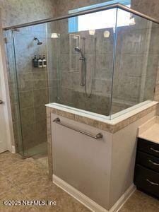 full bathroom with a shower stall and vanity