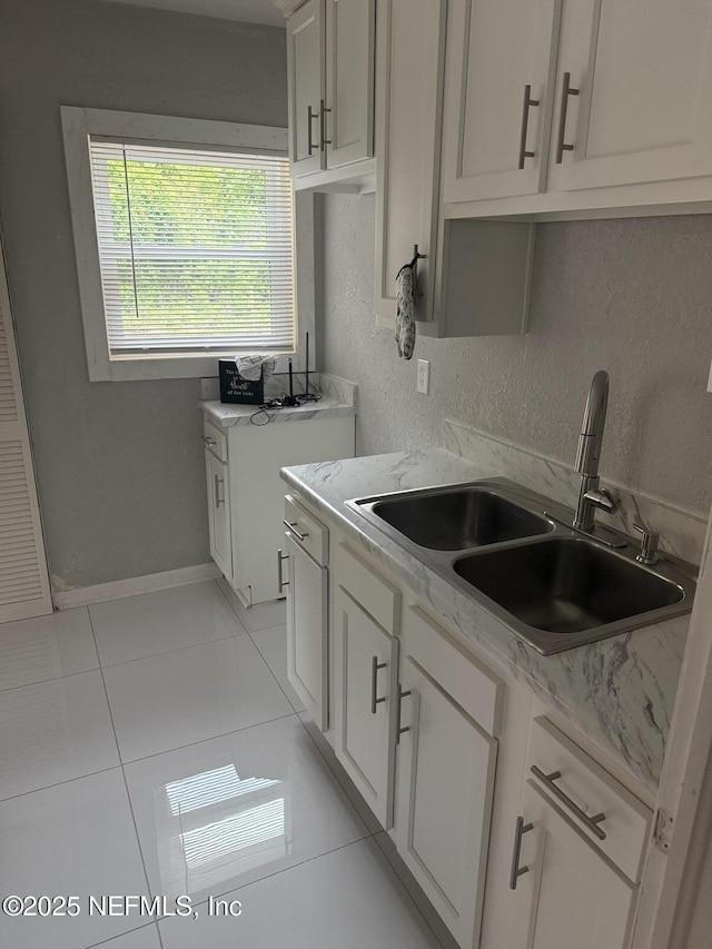 7205 Linda Dr, Jacksonville, FL 32208 - kitchen featuring a sink, light tile patterned floors, and white cabinets