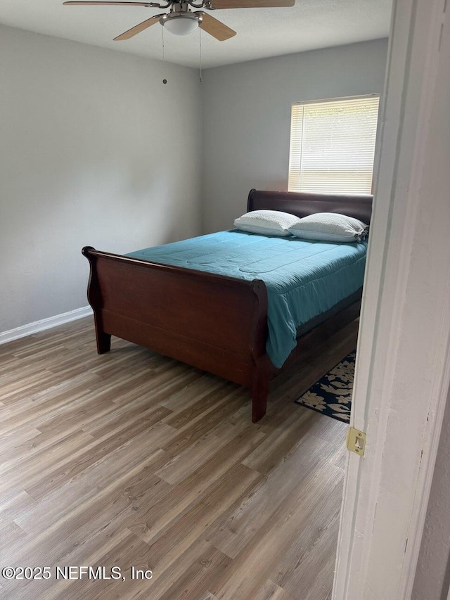 7205 Linda Dr, Jacksonville, FL 32208 - bedroom with wood finished floors, baseboards, and ceiling fan