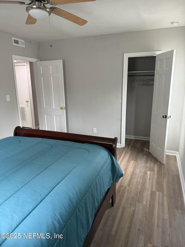 7205 Linda Dr, Jacksonville, FL 32208 - bedroom featuring wood finished floors, a closet, baseboards, and a ceiling fan