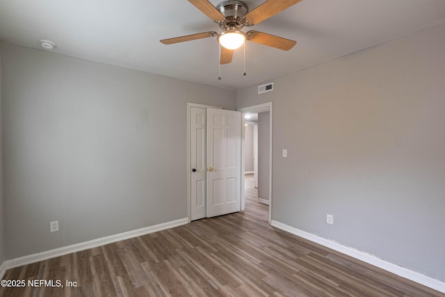 7205 Linda Dr, Jacksonville, FL 32208 - unfurnished bedroom with wood finished floors, baseboards, and ceiling fan