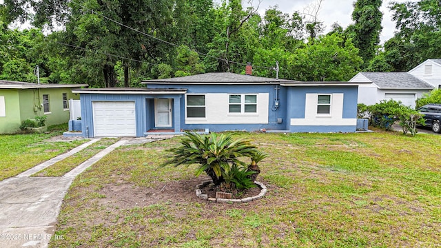 7205 Linda Dr, Jacksonville, FL 32208 - view of front of home featuring concrete driveway, a garage, and a front yard