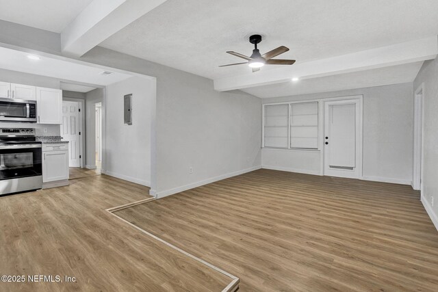 1021 Seminole Ave, Jacksonville, FL 32254 - unfurnished living room featuring beam ceiling, ceiling fan, light wood-style floors, baseboards, and electric panel