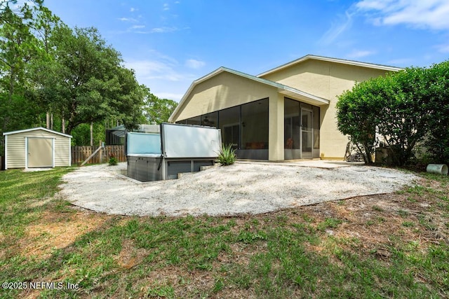 880 W American Eagle Dr, Saint Augustine, FL 32092 - rear view of property with a sunroom, a patio, stucco siding, and a hot tub