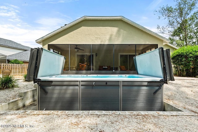 880 W American Eagle Dr, Saint Augustine, FL 32092 - back of house featuring a hot tub, ceiling fan, and a sunroom