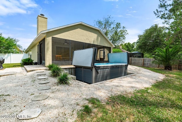 880 W American Eagle Dr, Saint Augustine, FL 32092 - rear view of property with a sunroom, a hot tub, a fenced backyard, and a ceiling fan