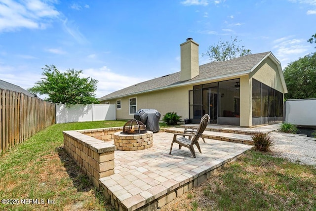880 W American Eagle Dr, Saint Augustine, FL 32092 - fenced backyard featuring a fire pit, grilling area, a sunroom, and a patio
