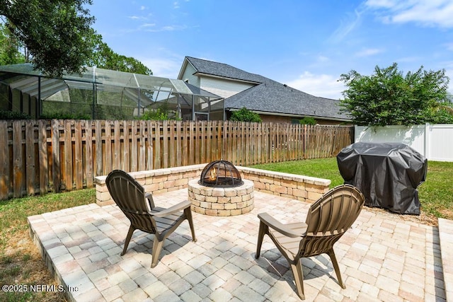 880 W American Eagle Dr, Saint Augustine, FL 32092 - fenced backyard with an outdoor fire pit, area for grilling, a patio area, and glass enclosure