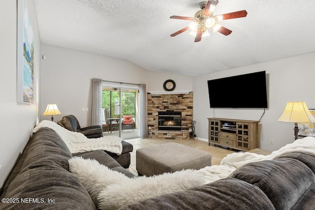 880 W American Eagle Dr, Saint Augustine, FL 32092 - living area with vaulted ceiling, ceiling fan, tile patterned flooring, a textured ceiling, and a glass covered fireplace
