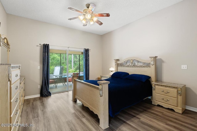 880 W American Eagle Dr, Saint Augustine, FL 32092 - bedroom featuring access to exterior, wood finished floors, a textured ceiling, baseboards, and ceiling fan