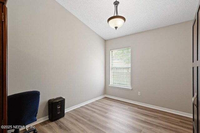 880 W American Eagle Dr, Saint Augustine, FL 32092 - unfurnished office with light wood-type flooring, baseboards, and a textured ceiling