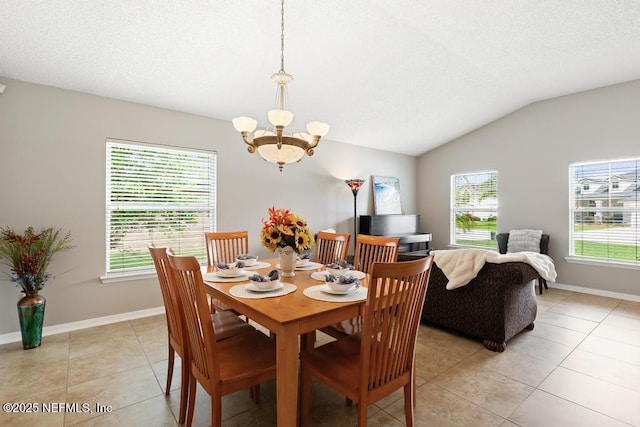 880 W American Eagle Dr, Saint Augustine, FL 32092 - dining room with a chandelier, lofted ceiling, light tile patterned floors, baseboards, and a textured ceiling