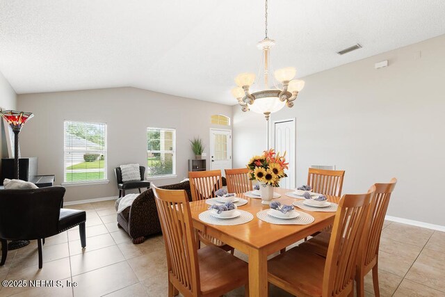 880 W American Eagle Dr, Saint Augustine, FL 32092 - dining area featuring light tile patterned floors, a chandelier, vaulted ceiling, and baseboards