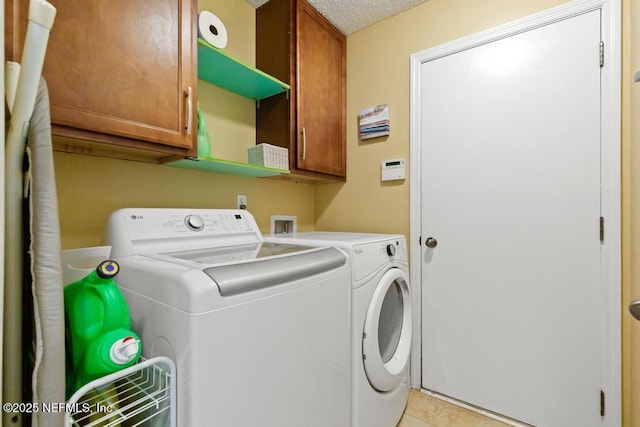 880 W American Eagle Dr, Saint Augustine, FL 32092 - washroom featuring independent washer and dryer, cabinet space, light tile patterned floors, and a textured ceiling