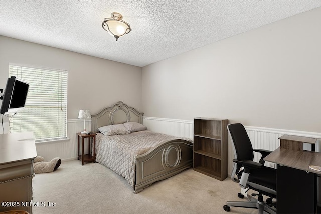880 W American Eagle Dr, Saint Augustine, FL 32092 - bedroom with a wainscoted wall, a textured ceiling, light carpet, and an office area