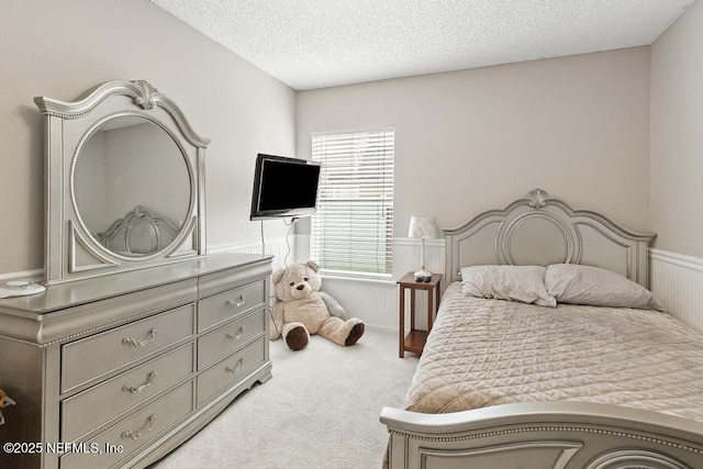 880 W American Eagle Dr, Saint Augustine, FL 32092 - bedroom with carpet floors, a textured ceiling, and wainscoting