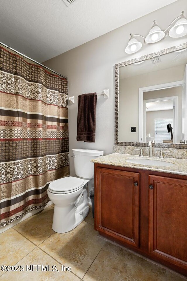 880 W American Eagle Dr, Saint Augustine, FL 32092 - bathroom with toilet, vanity, tile patterned flooring, and a shower with curtain