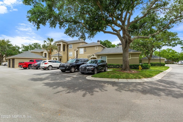 view of front facade with uncovered parking