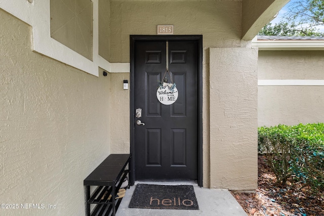 entrance to property with stucco siding
