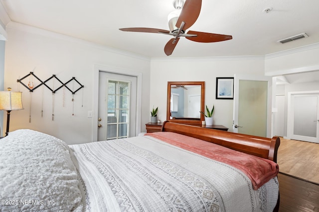 bedroom featuring wood finished floors, crown molding, and ceiling fan