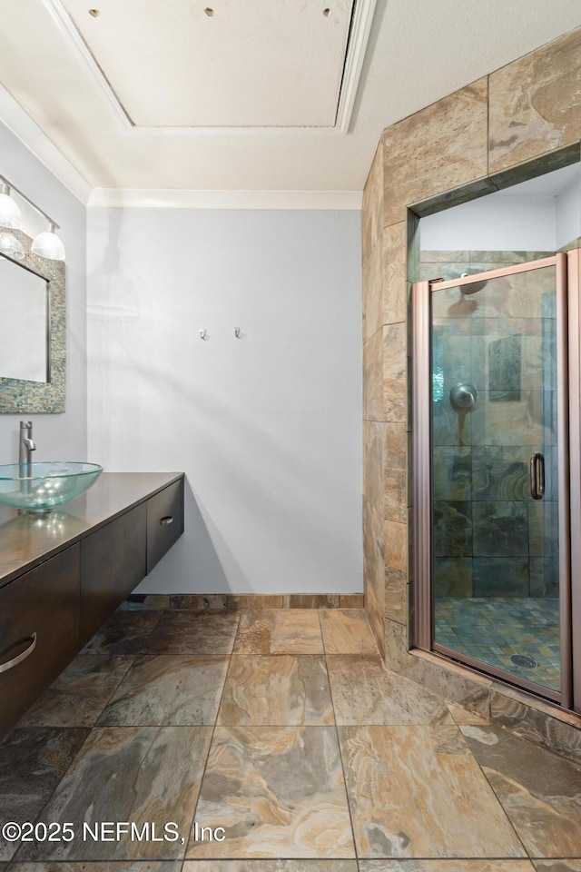 bathroom featuring a stall shower, vanity, and stone finish floors