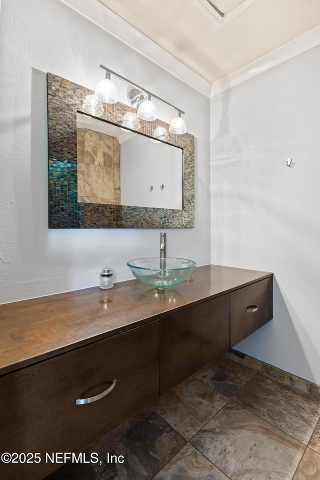 bathroom featuring vanity and ornamental molding