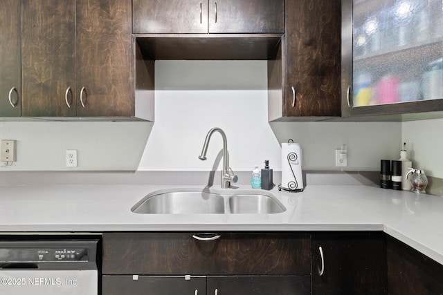 kitchen with dishwashing machine, a sink, dark brown cabinetry, and light countertops