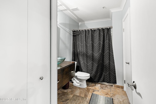 bathroom featuring crown molding, stone finish flooring, toilet, vanity, and a shower with shower curtain