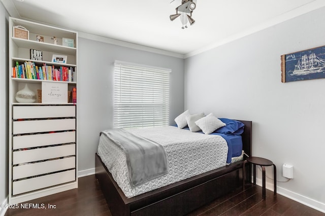 bedroom featuring wood finished floors, baseboards, and ornamental molding