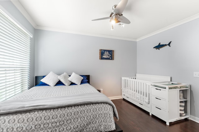 bedroom with dark wood-style flooring, crown molding, baseboards, and ceiling fan