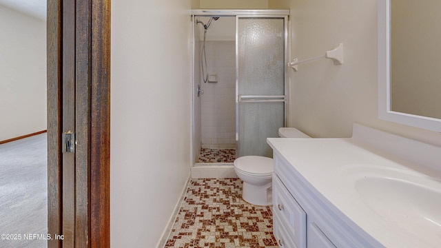 full bath with a shower stall, toilet, vanity, and baseboards