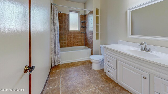 full bath with toilet, vanity, tile patterned floors, and shower / tub combo