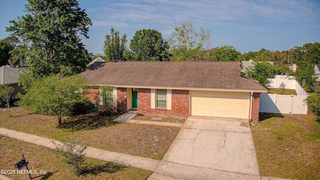 view of front of home featuring an attached garage, brick siding, concrete driveway, roof with shingles, and a gate