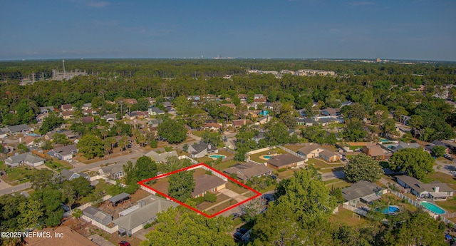 view of property location with nearby suburban area, property parcel outlined, and a forest
