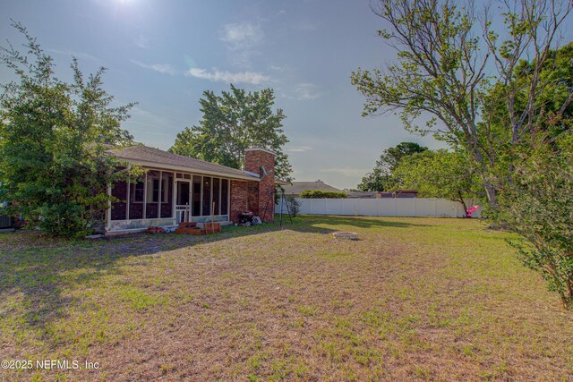view of yard featuring a sunroom