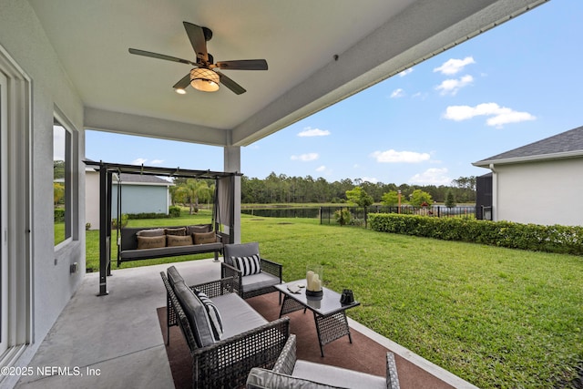view of patio with an outdoor living space and a ceiling fan