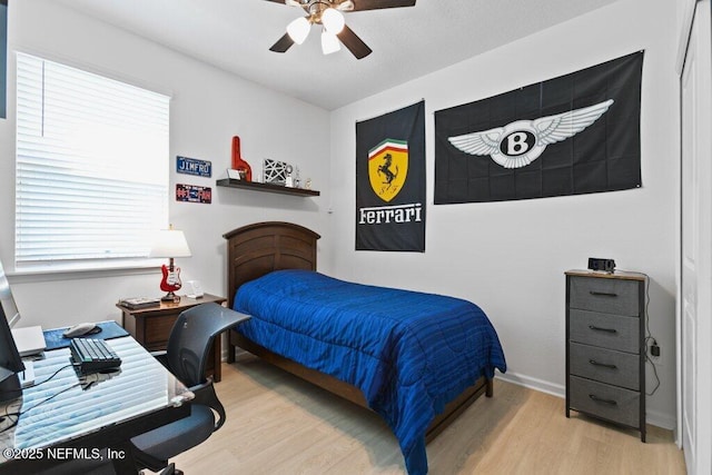 567 Flach Dr, Saint Johns, FL 32259 - bedroom with light wood-style flooring, an office area, a ceiling fan, and baseboards