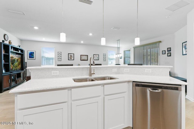 567 Flach Dr, Saint Johns, FL 32259 - kitchen featuring stainless steel dishwasher, a sink, light wood-style flooring, white cabinetry, and light stone countertops