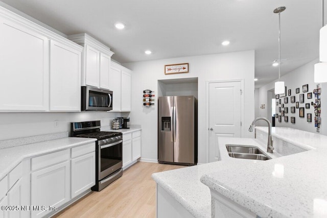 567 Flach Dr, Saint Johns, FL 32259 - kitchen featuring stainless steel appliances, a sink, white cabinetry, light wood-type flooring, and recessed lighting