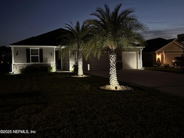 567 Flach Dr, Saint Johns, FL 32259 - ranch-style home featuring driveway, stone siding, a garage, and a front lawn