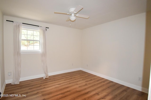 empty room with light wood-style flooring, a ceiling fan, and baseboards