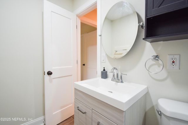 bathroom featuring vanity and toilet