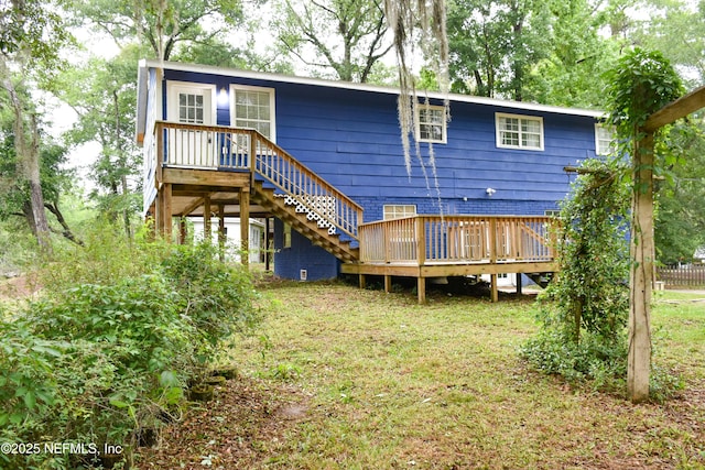 rear view of property featuring a deck and stairway