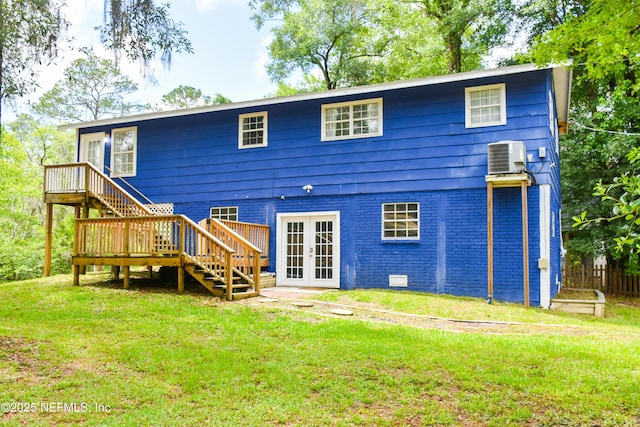 rear view of house with stairs, french doors, a wooden deck, and a yard
