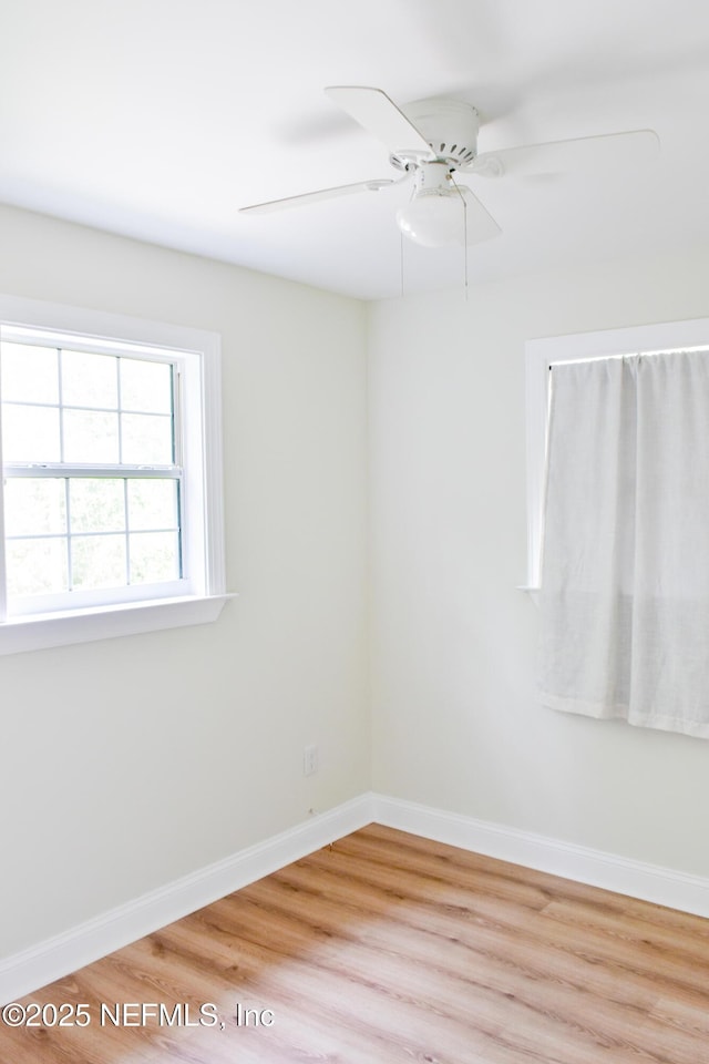 empty room with light wood-style flooring, baseboards, and ceiling fan