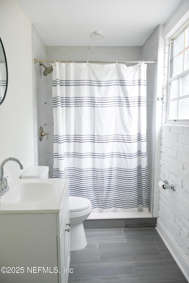 full bathroom featuring toilet, vanity, a shower with curtain, and wood finished floors